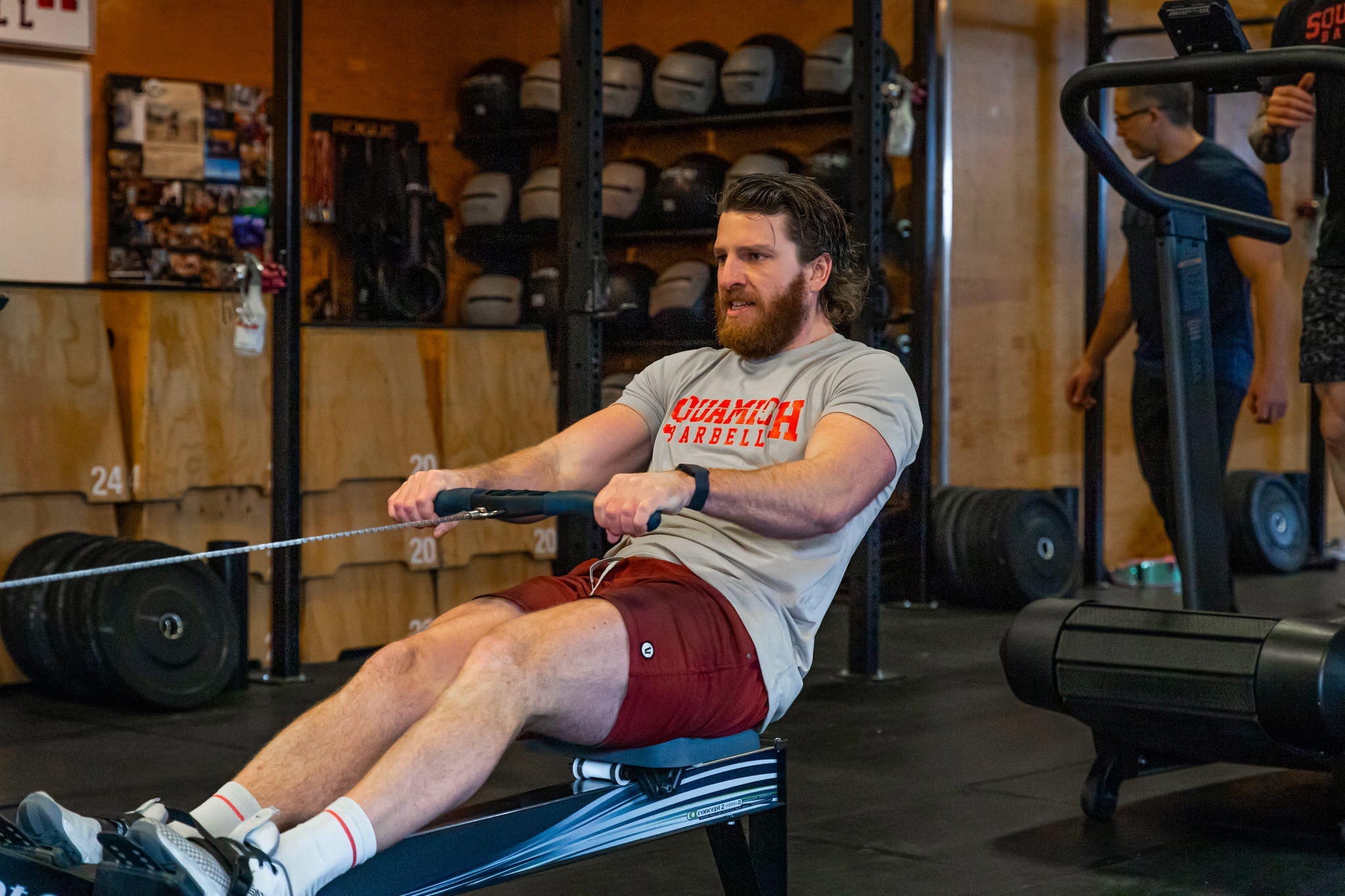 Athlete on a rowing machine in a CrossFit gym