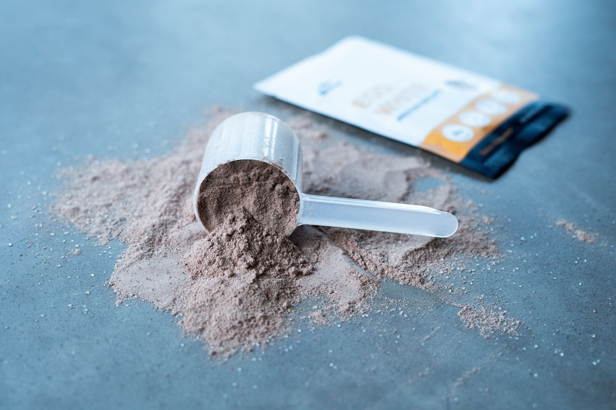Protein Powder in a Scoop with a Single Serve Blonyx Egg White Protein Isolate Serving in the Background