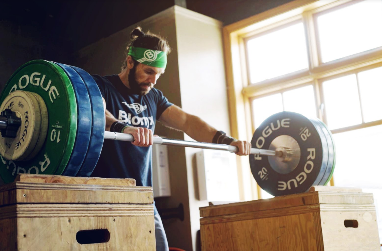 A CrossFit athlete in a Blonyx tee shirt holding a barbell