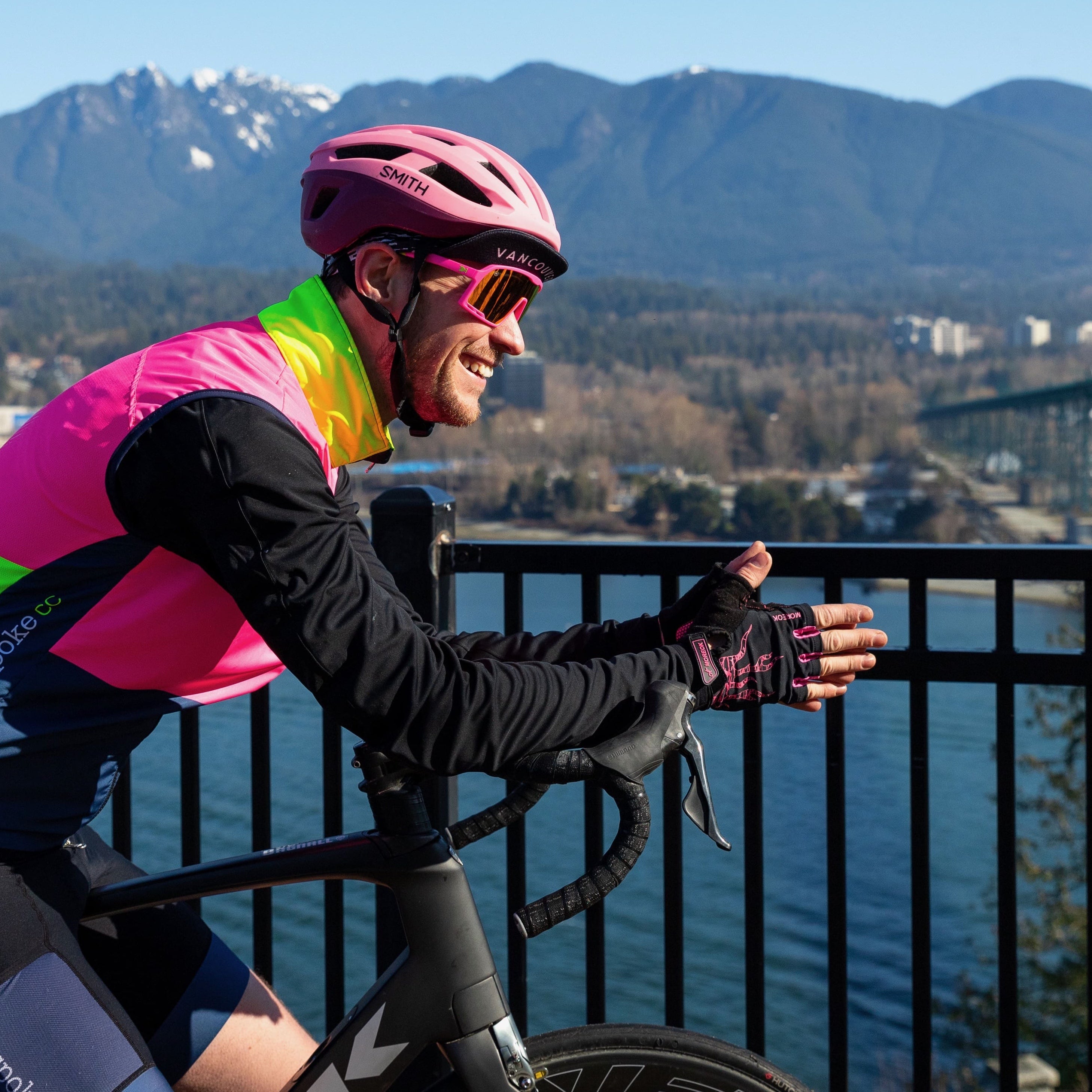 Cyclist looking out over North Vancouver and the Lions Gate Bridge