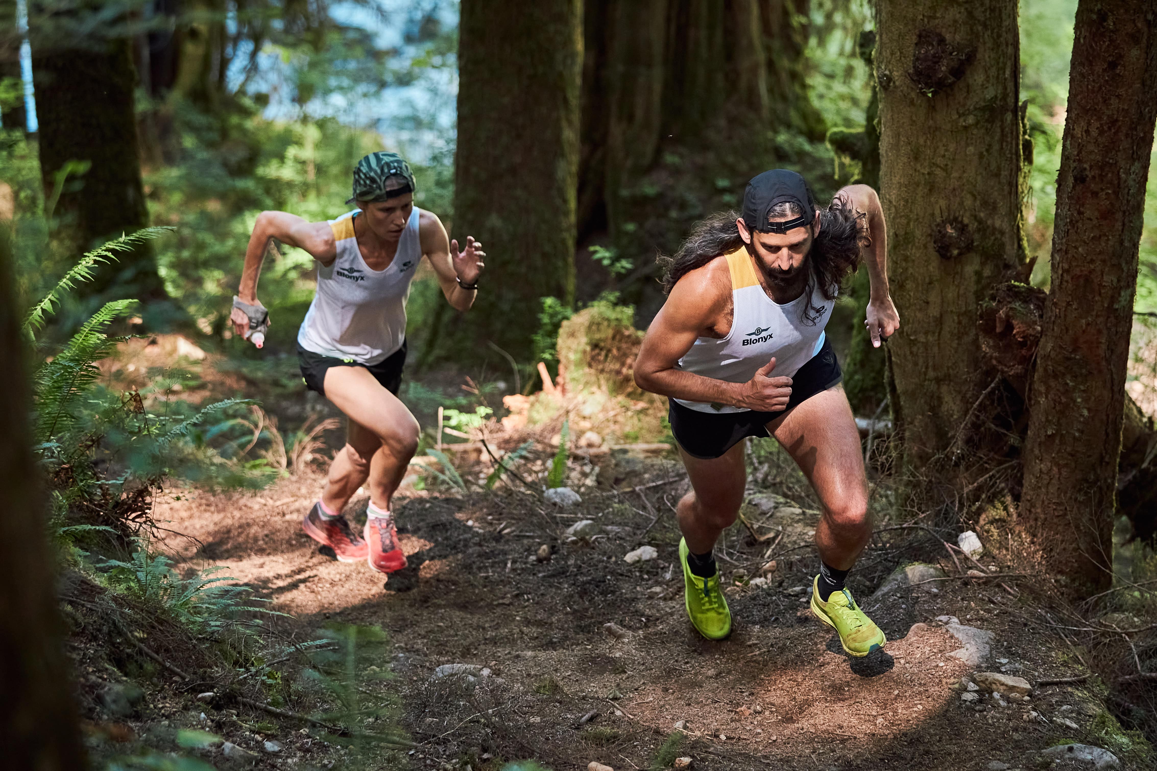 Pair of trail runners powering up an incline