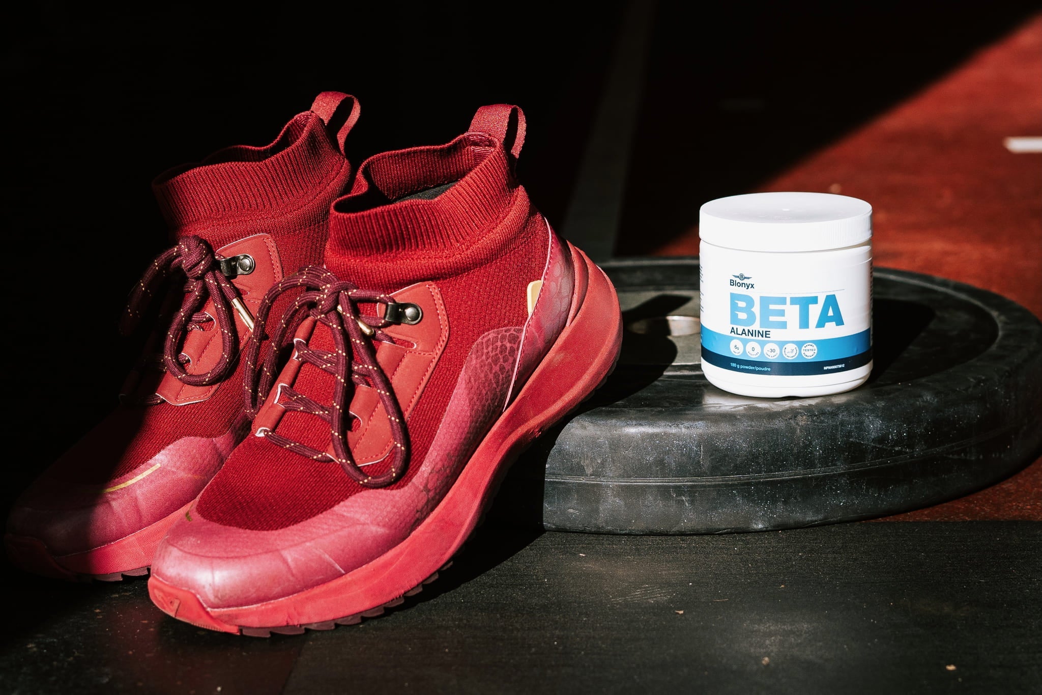 Running shoes and Blonyx Beta Alanine on a 45lb plate