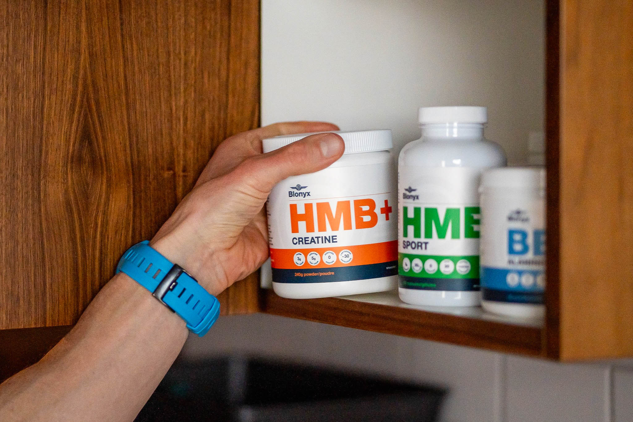 Athlete taking Blonyx HMB+ Creatine out of the cupboard