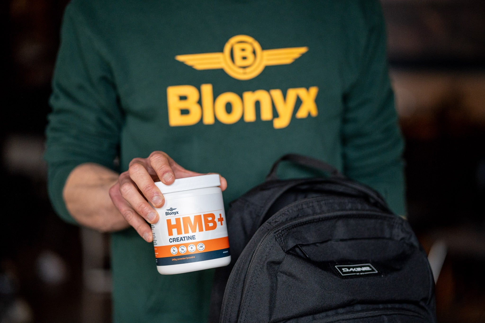 Athlete taking Blonyx HMB+ Creatine out of a backpack