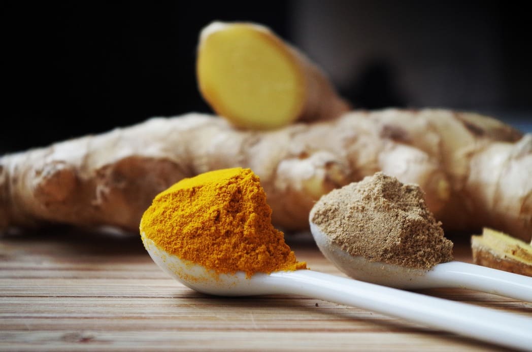 Teaspoon of Tumeric and Tumeric Root