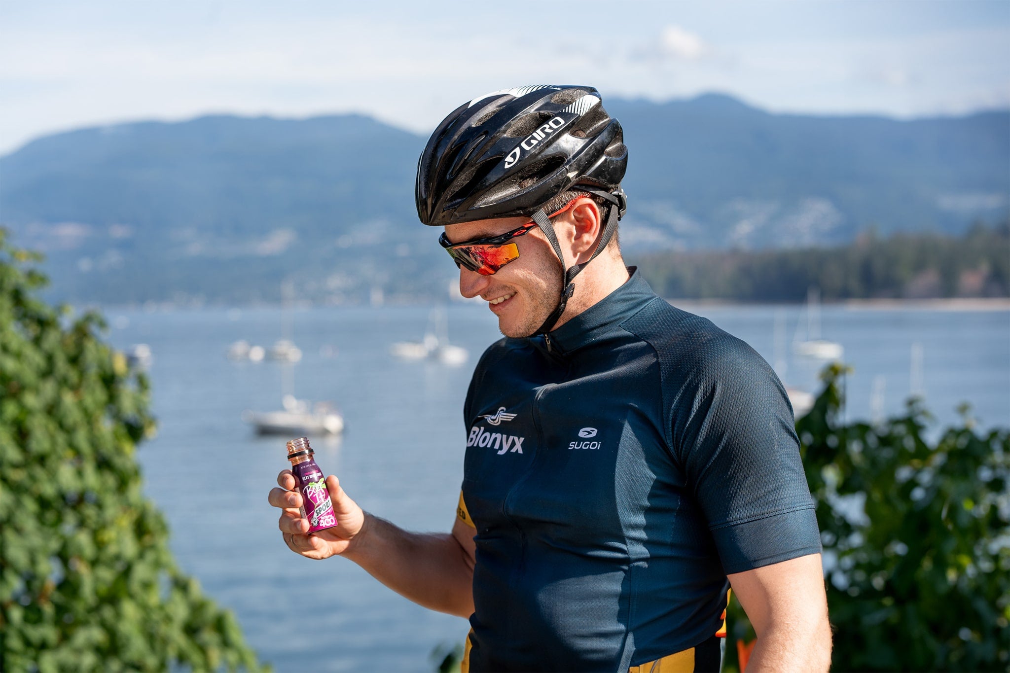 Cyclist drinking a Beet It Sport Nitrate 400 shot