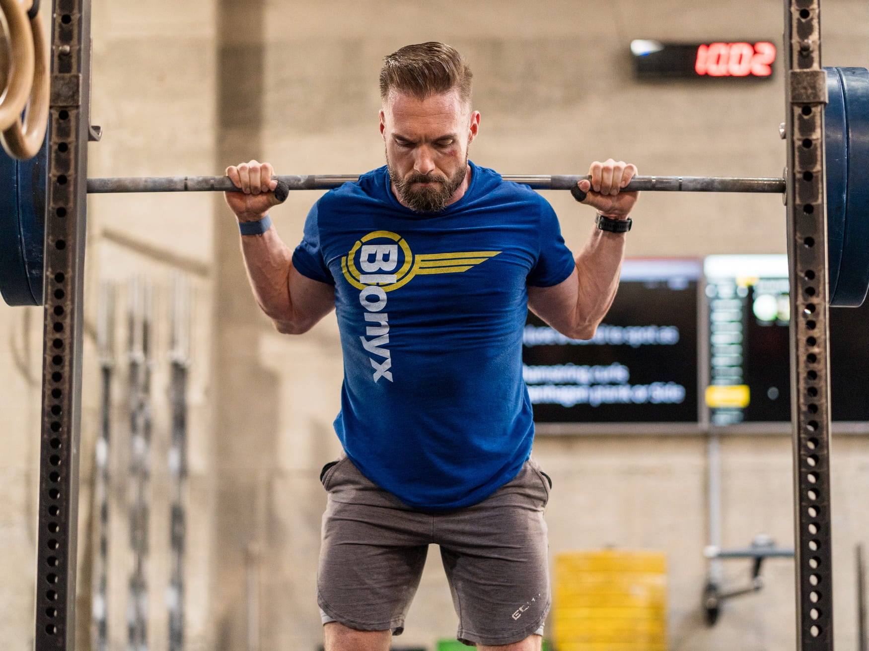 A CrossFit athlete performing squats.