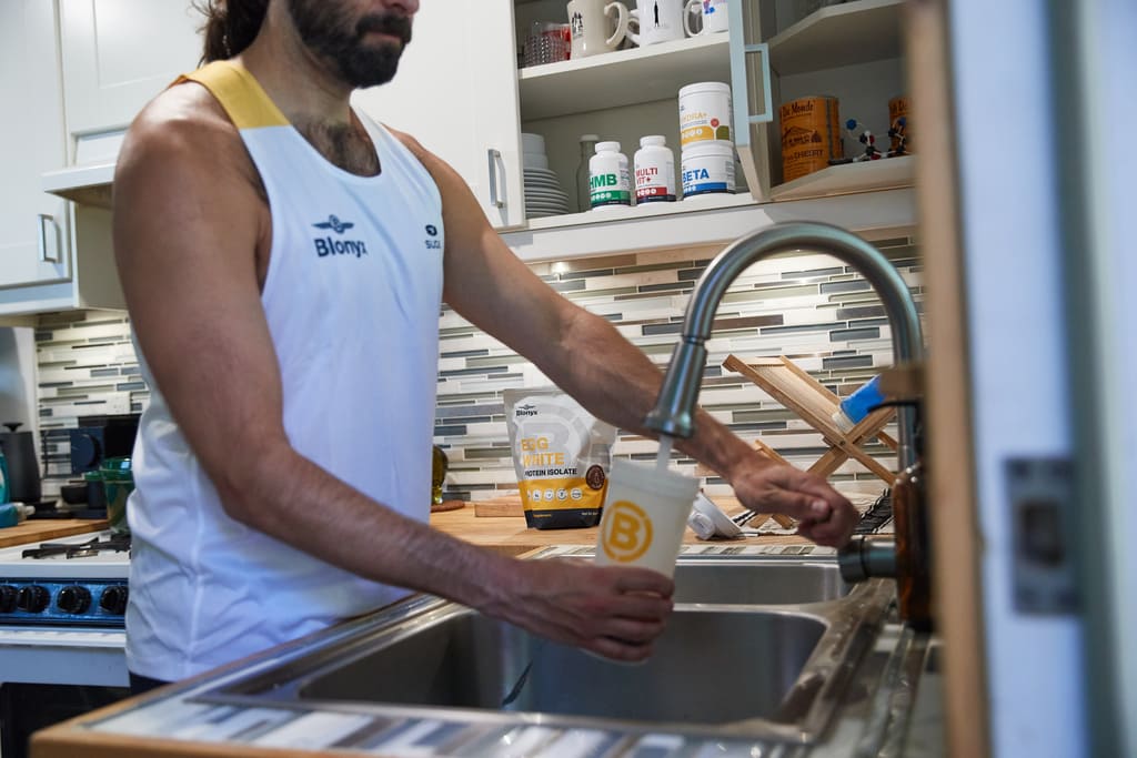 Person Making a Blonyx Egg White Protein Isolate Shake