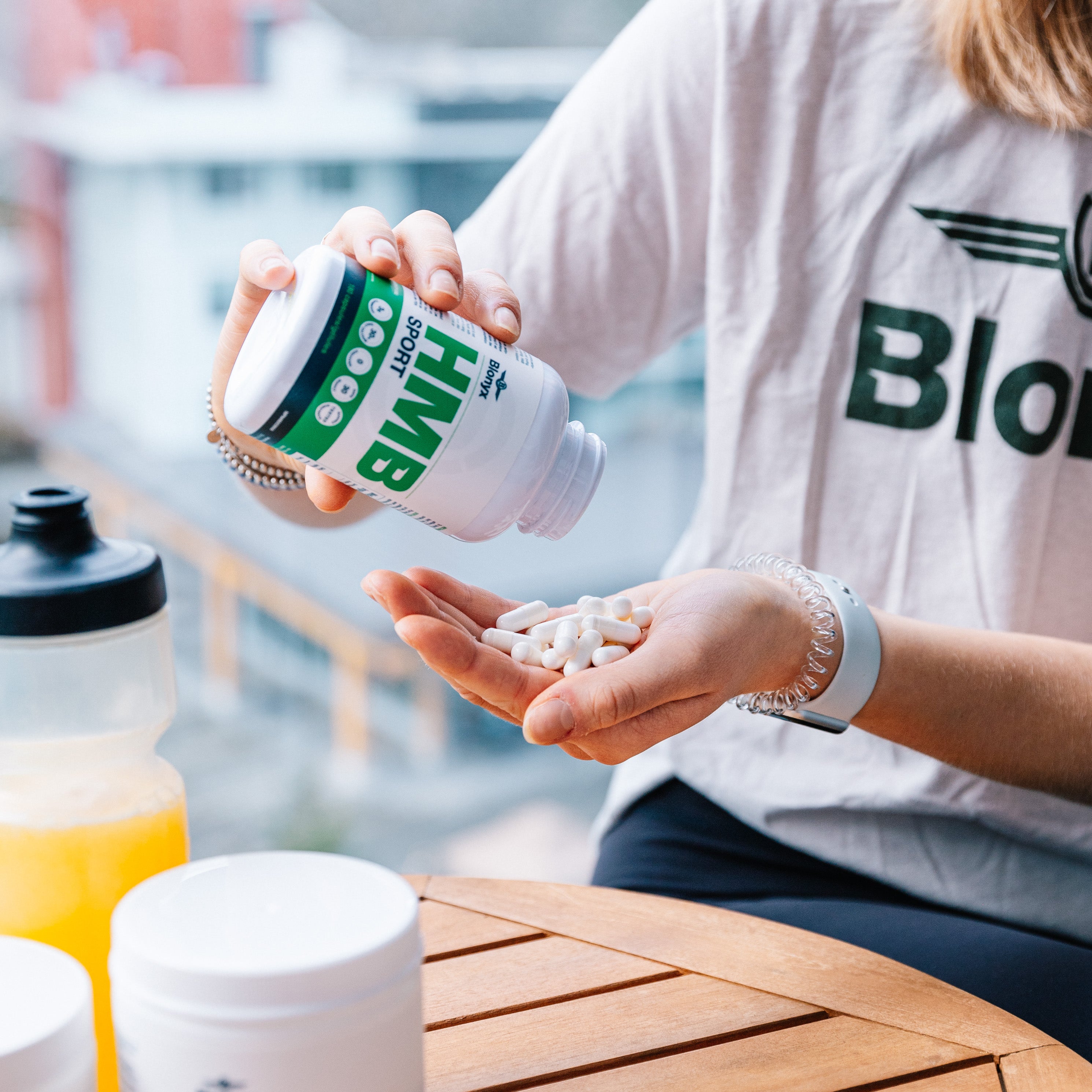 Person pouring Blonyx HMB Sport capsules into their hand