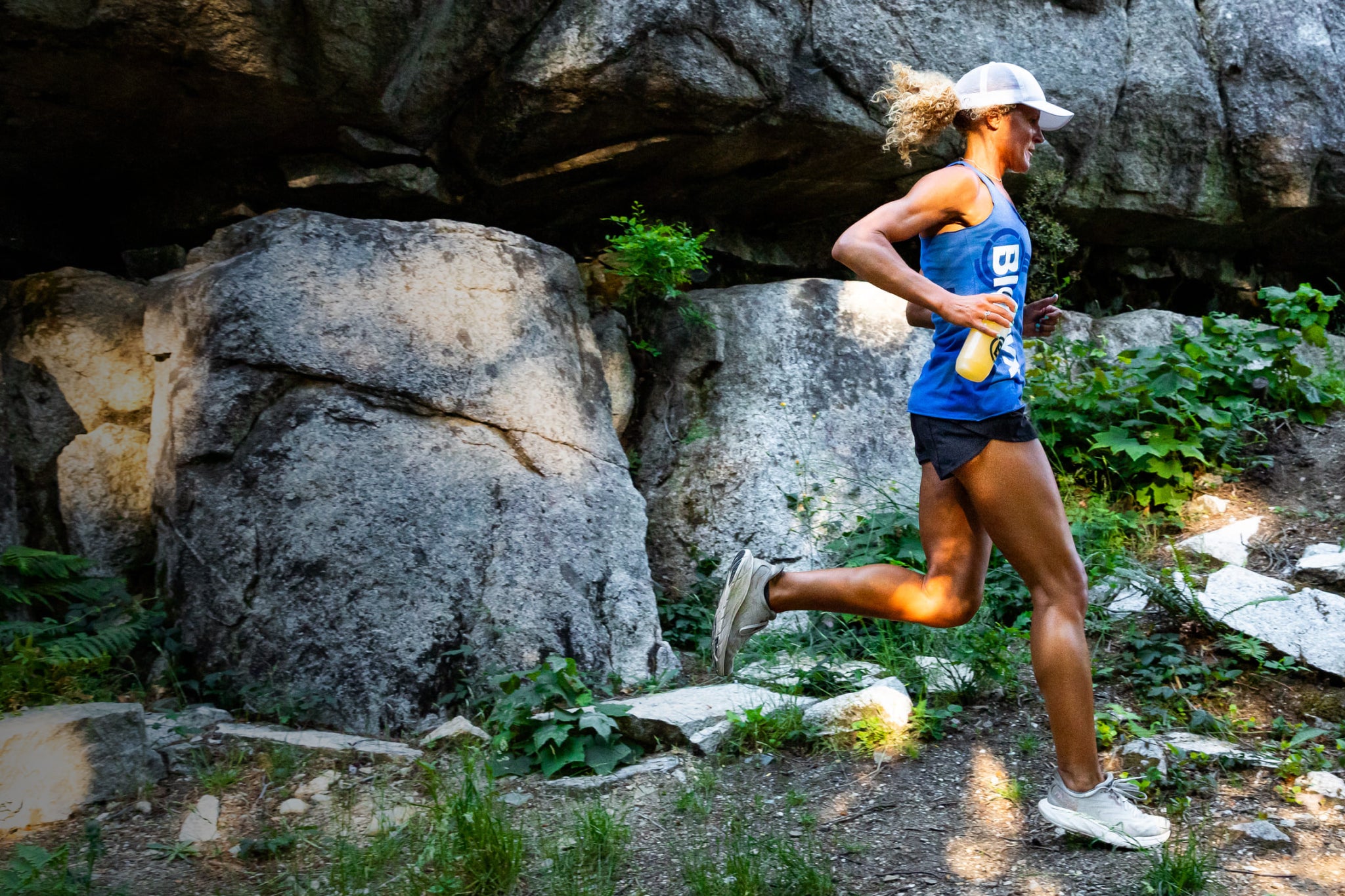 Trail runner moving along a rocky cliffside