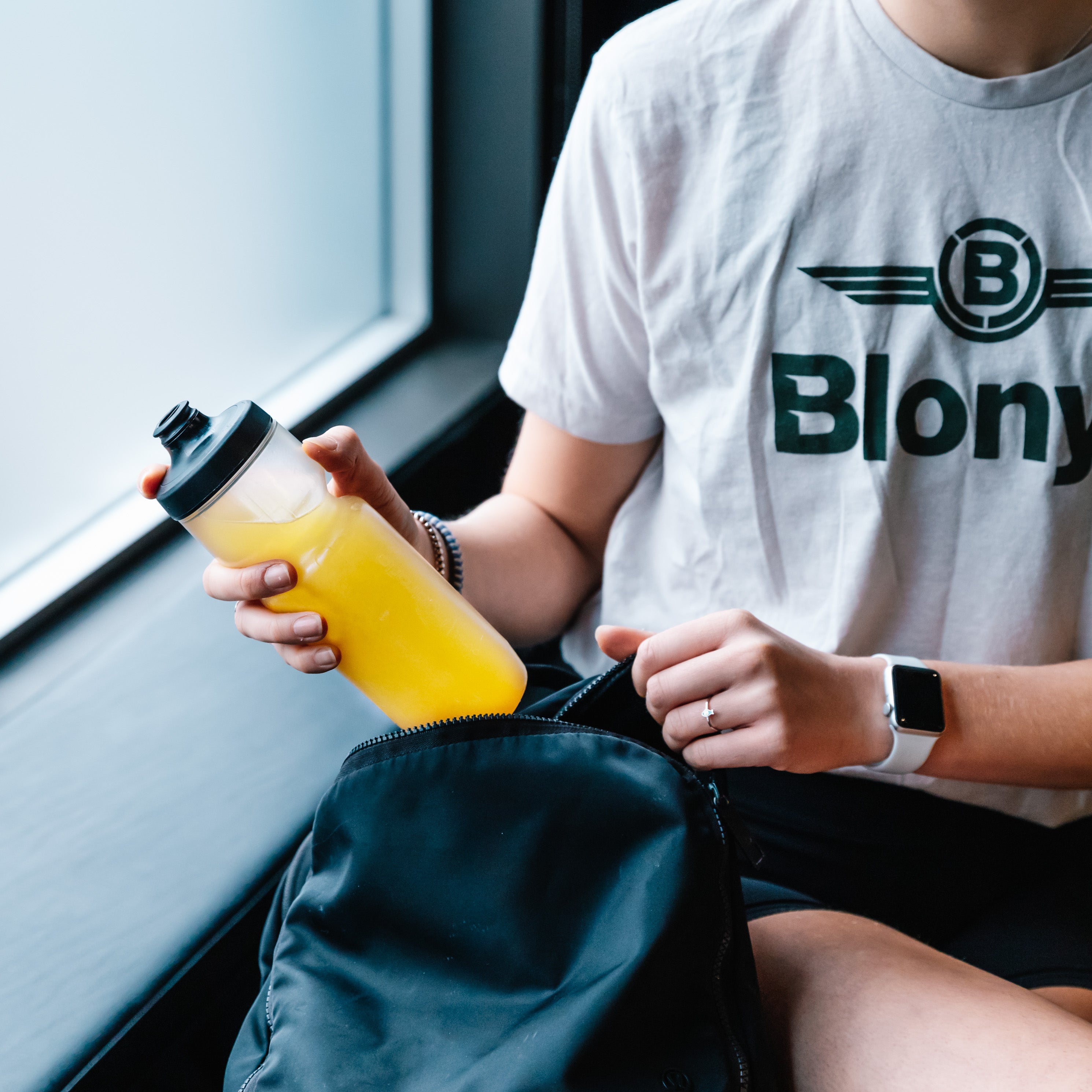 Triathlete taking a bottle of Blonyx Hydra+ out of their bag