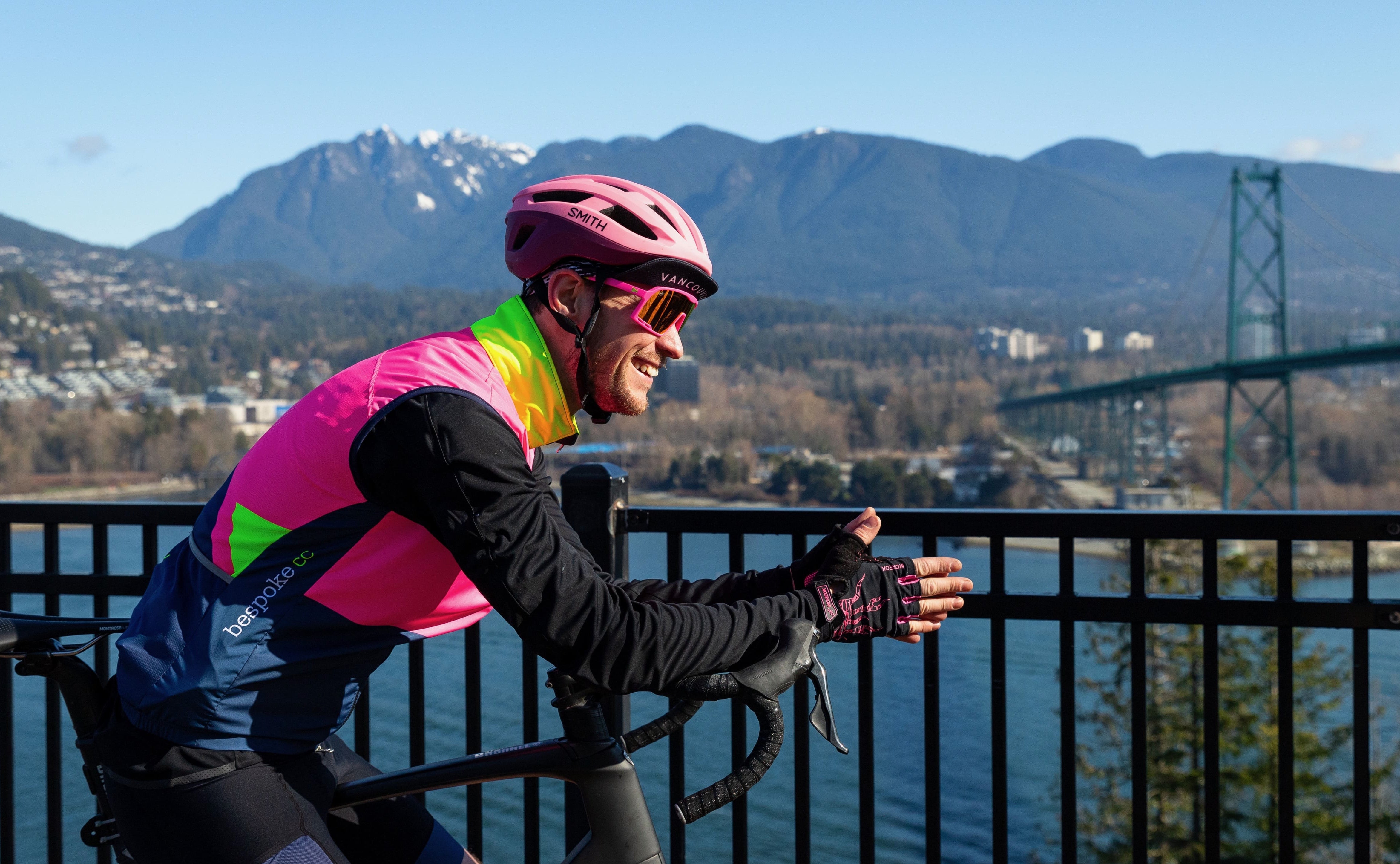 Cyclist looking out over North Vancouver and the Lions Gate Bridge