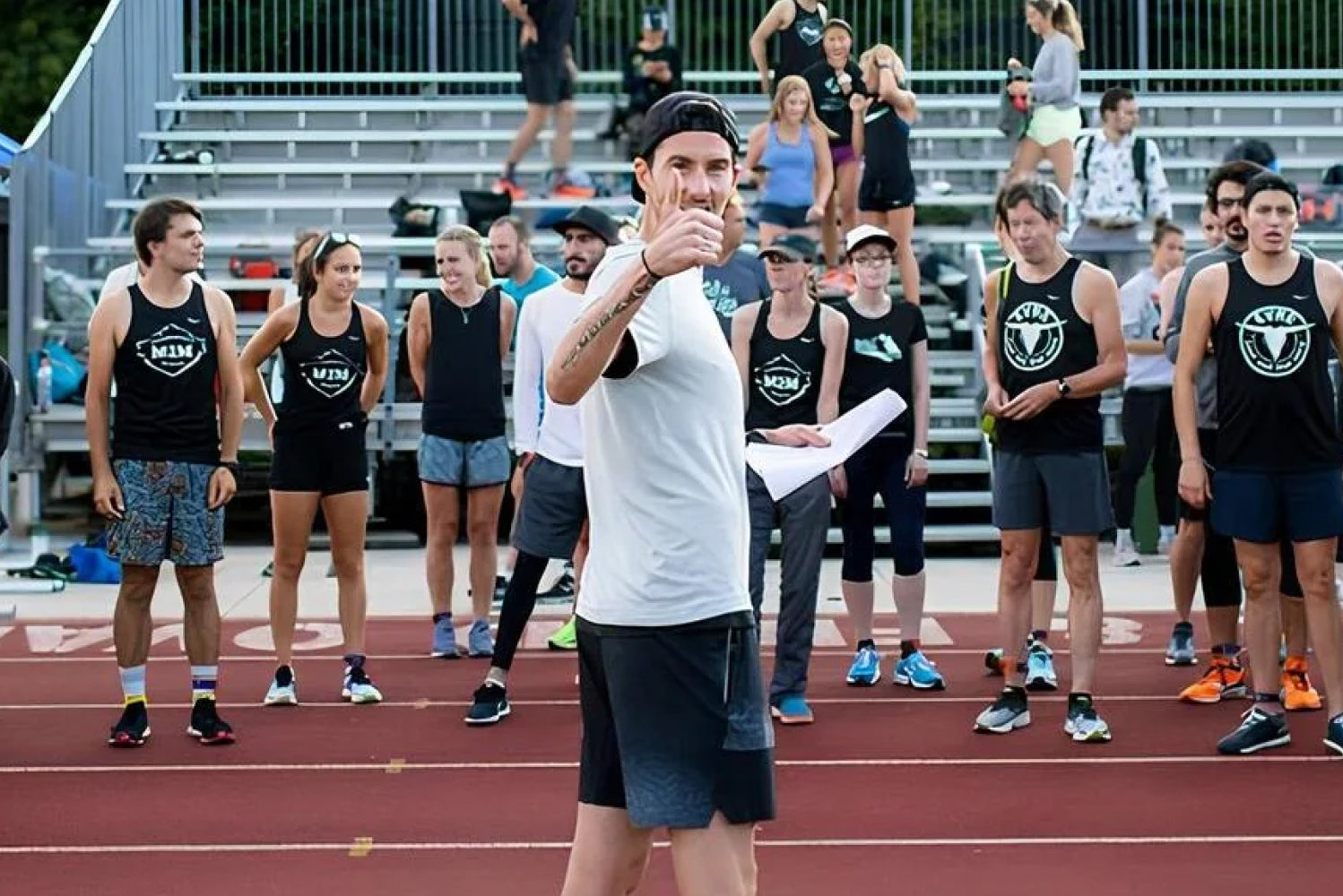 Coach Rob Watson teaching a group of runners